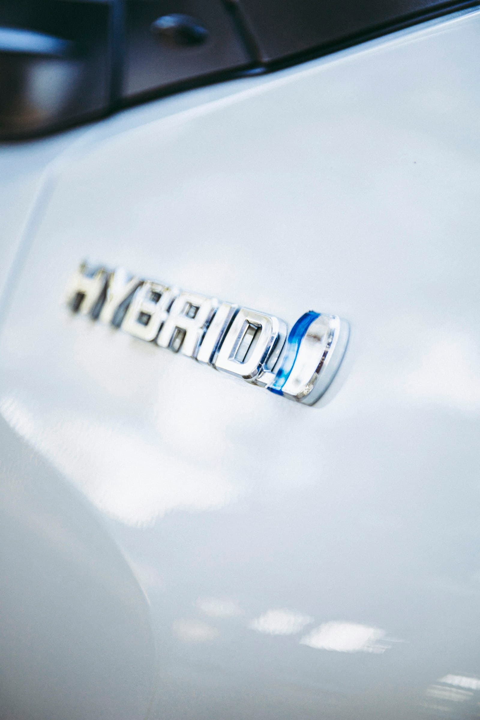 Hybrid vehicle badge — modern petrol-electric servicing and battery-related work